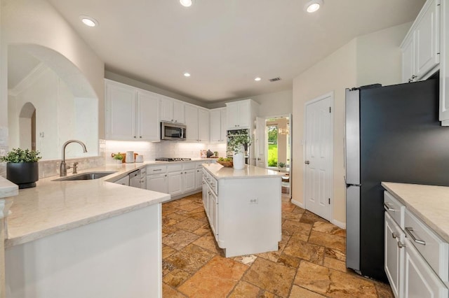 4700 River Place Blvd Unit 3, Austin, TX 78730 - kitchen with stone tile floors, appliances with stainless steel finishes, white cabinetry, backsplash, and recessed lighting