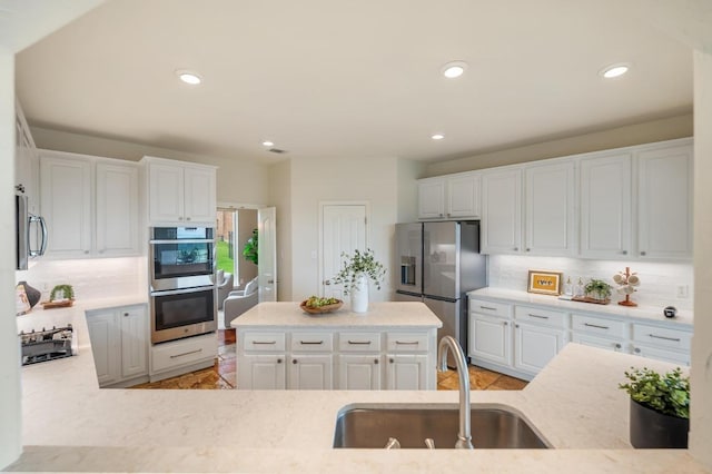 4700 River Place Blvd Unit 3, Austin, TX 78730 - kitchen with backsplash, stainless steel appliances, white cabinetry, and recessed lighting