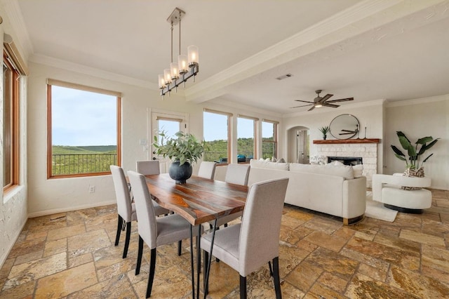 4700 River Place Blvd Unit 3, Austin, TX 78730 - dining room with stone tile floors, ornamental molding, a fireplace, and a ceiling fan