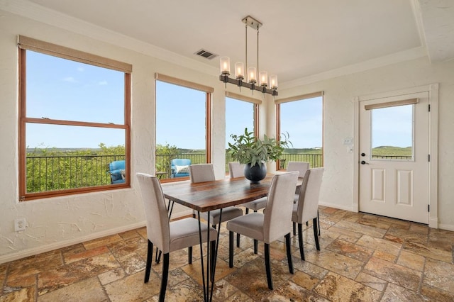 4700 River Place Blvd Unit 3, Austin, TX 78730 - dining space featuring stone tile floors, crown molding, and a chandelier