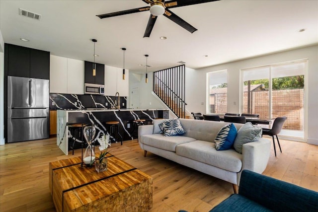 2902 Gonzales St Unit 2, Austin, TX 78702 - living area with a ceiling fan, light wood finished floors, stairs, and recessed lighting