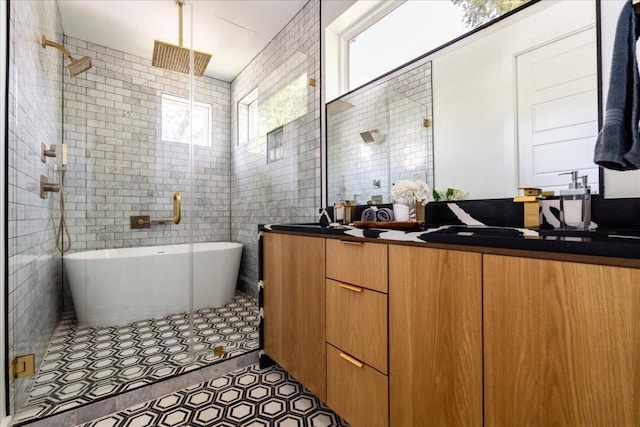 2902 Gonzales St Unit 2, Austin, TX 78702 - full bath featuring double vanity, a stall shower, a soaking tub, tile walls, and tile patterned floors