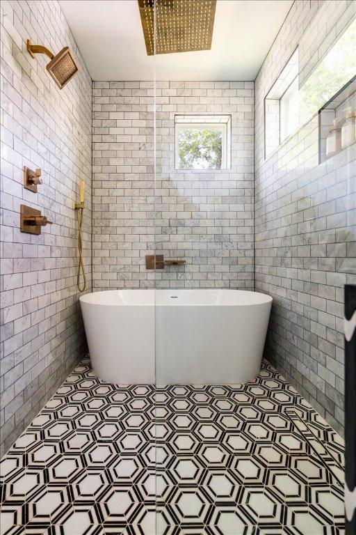 2902 Gonzales St Unit 2, Austin, TX 78702 - full bathroom featuring a soaking tub and tile walls