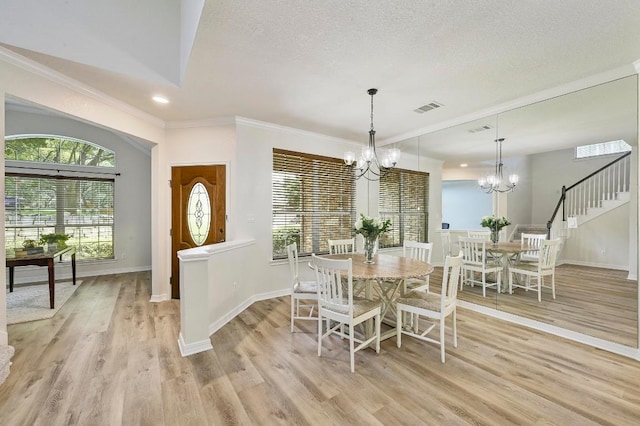 12600 Grimes Ranch Ct, Austin, TX 78732 - dining area with a chandelier, light wood-style floors, crown molding, recessed lighting, and a textured ceiling