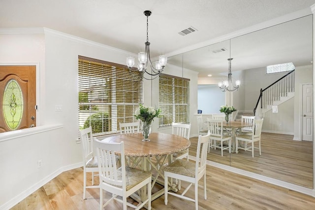 12600 Grimes Ranch Ct, Austin, TX 78732 - dining space featuring a chandelier, light wood-style flooring, stairs, and ornamental molding