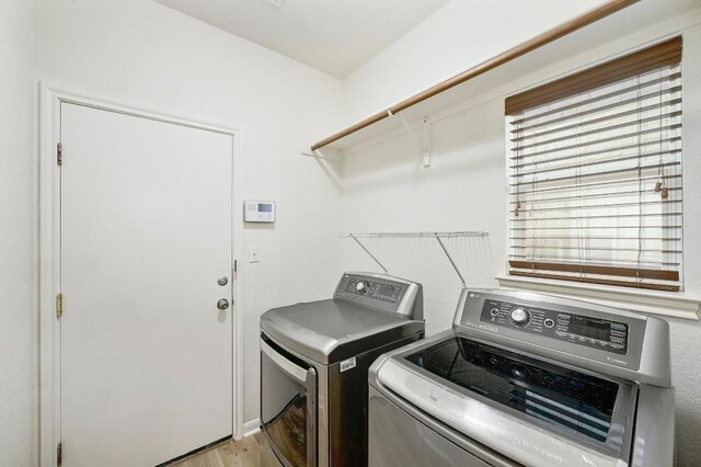 12600 Grimes Ranch Ct, Austin, TX 78732 - washroom featuring washer and clothes dryer and light wood-type flooring