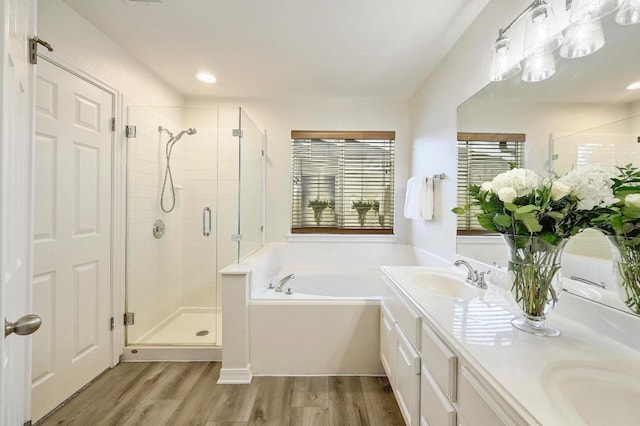 12600 Grimes Ranch Ct, Austin, TX 78732 - full bath featuring a shower stall, a garden tub, wood finished floors, and double vanity