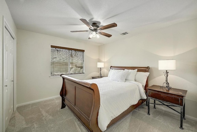 12600 Grimes Ranch Ct, Austin, TX 78732 - bedroom with light colored carpet, a ceiling fan, and a closet
