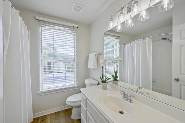 12600 Grimes Ranch Ct, Austin, TX 78732 - full bathroom with plenty of natural light, vanity, wood finished floors, and a shower with shower curtain