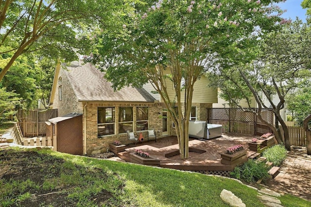 12600 Grimes Ranch Ct, Austin, TX 78732 - back of house featuring brick siding, roof with shingles, a wooden deck, and a patio