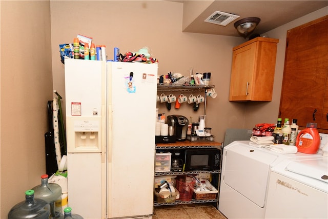 laundry area with washer and clothes dryer and cabinets