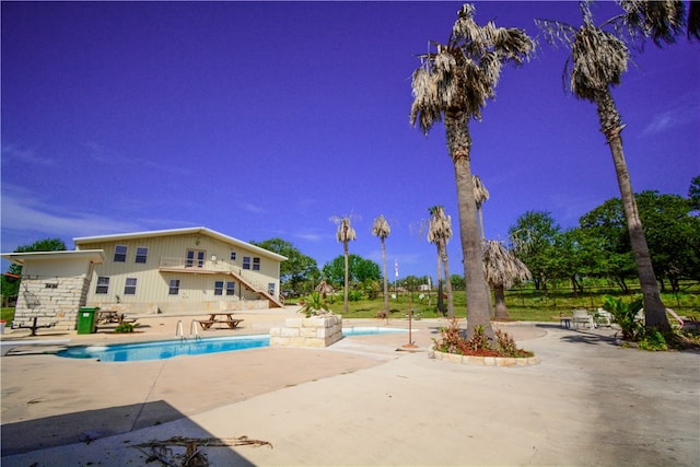 view of swimming pool featuring a patio area