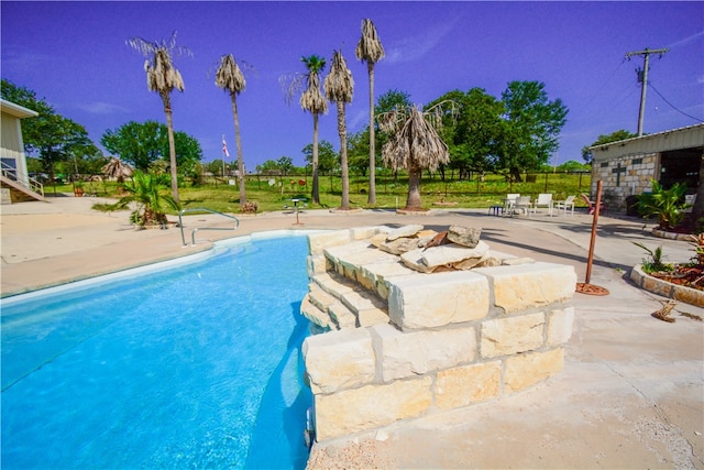 view of swimming pool with a patio area