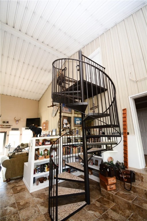 stairs featuring wood ceiling and lofted ceiling