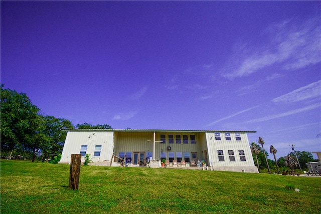 back of house featuring a patio and a yard