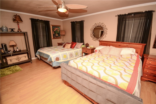 bedroom featuring light wood-type flooring, ceiling fan, and crown molding