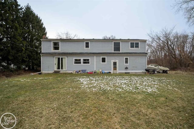 rear view of property featuring a patio and a lawn