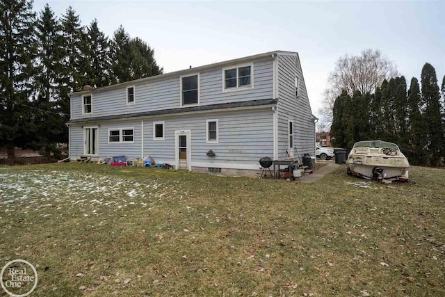 rear view of property with a yard