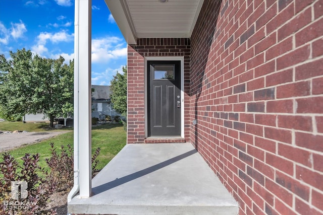 doorway to property featuring a lawn