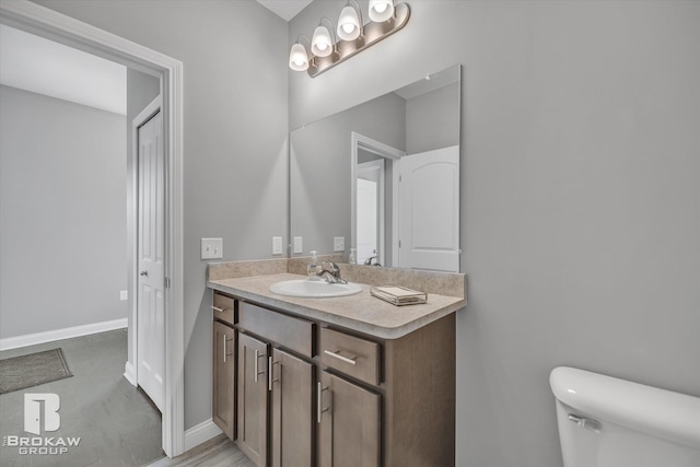 bathroom with tile floors, toilet, a chandelier, and vanity with extensive cabinet space