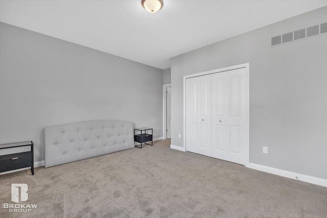 unfurnished room featuring light colored carpet