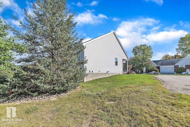 view of side of property with a garage and a yard