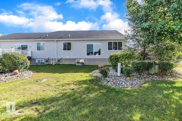 rear view of house featuring a yard