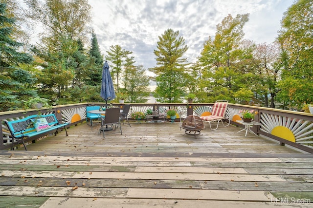 wooden deck featuring an outdoor fire pit