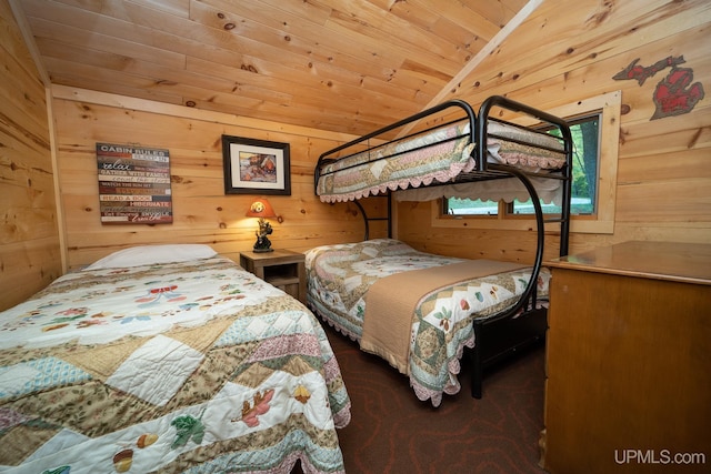 bedroom featuring vaulted ceiling, wooden ceiling, and wooden walls