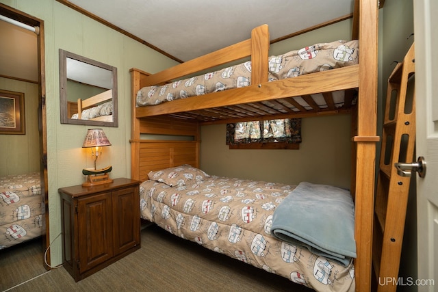 bedroom with dark carpet and crown molding