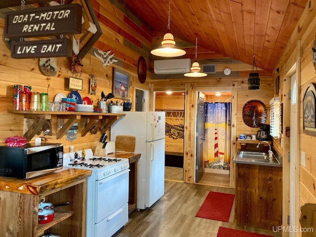 kitchen featuring an AC wall unit, wood walls, sink, wooden ceiling, and white appliances