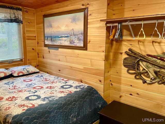 bedroom featuring wood walls