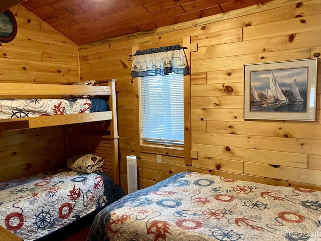 bedroom with wooden walls, wooden ceiling, and vaulted ceiling