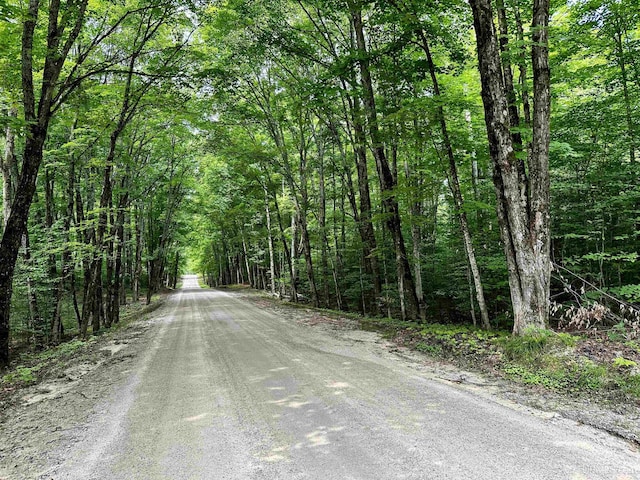 view of road featuring a forest view