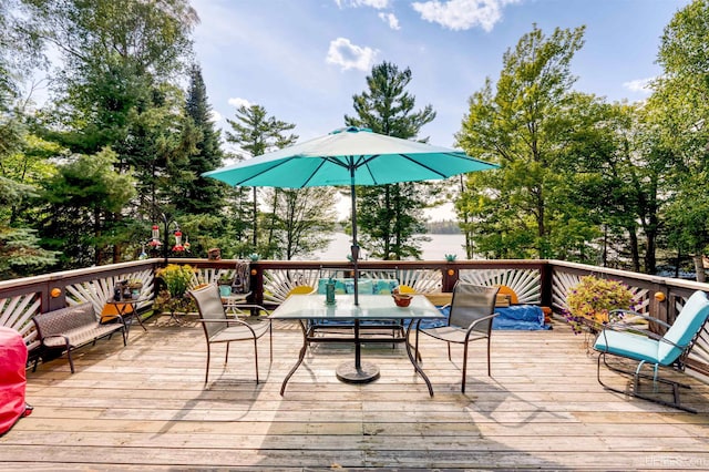 wooden terrace featuring outdoor dining space