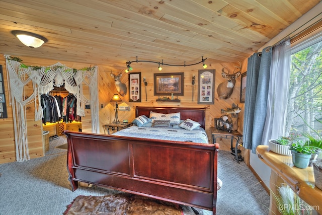 carpeted bedroom featuring wooden walls and wood ceiling