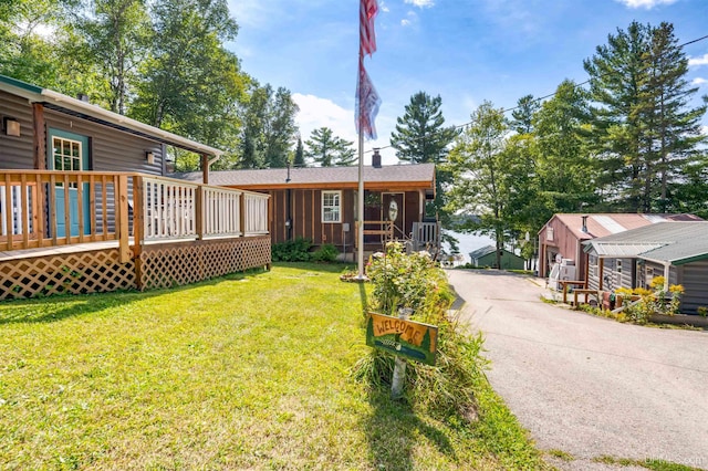 exterior space featuring a deck and a front yard