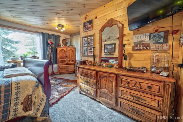 bedroom featuring wooden ceiling and wood walls