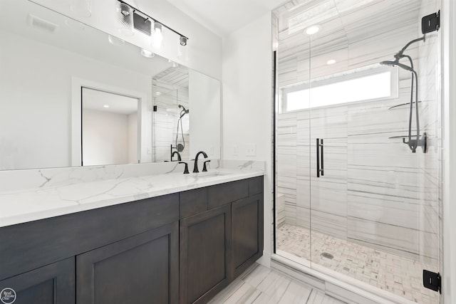 bathroom with vanity and a shower with shower door