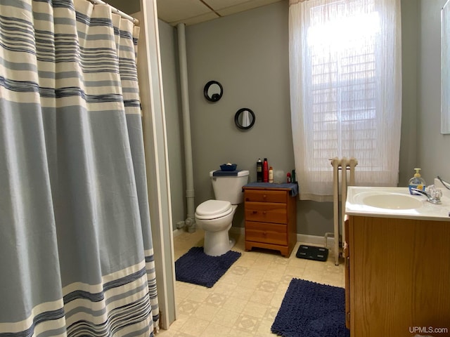 bathroom with toilet, tile floors, and vanity