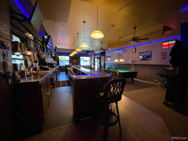 interior space with billiards, ceiling fan, and bar