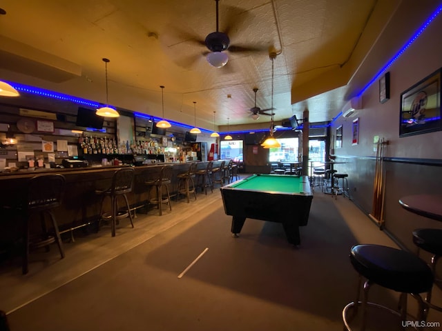 rec room with concrete floors, bar, billiards, and ceiling fan