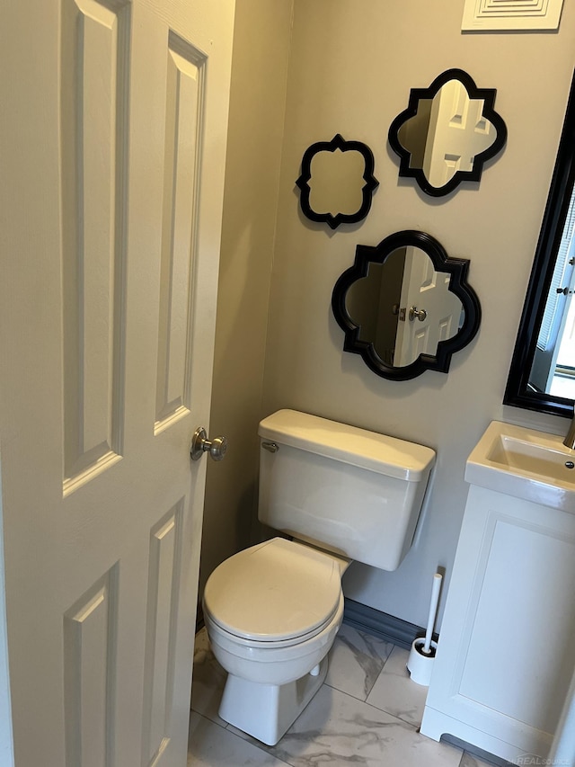 bathroom with vanity, toilet, and tile patterned floors