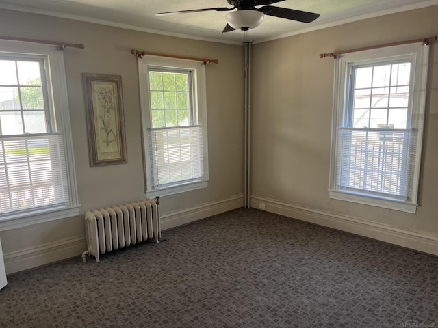 empty room with radiator heating unit, a wealth of natural light, and ceiling fan