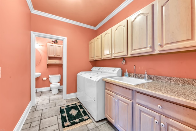 laundry area featuring cabinets, independent washer and dryer, crown molding, sink, and light tile floors