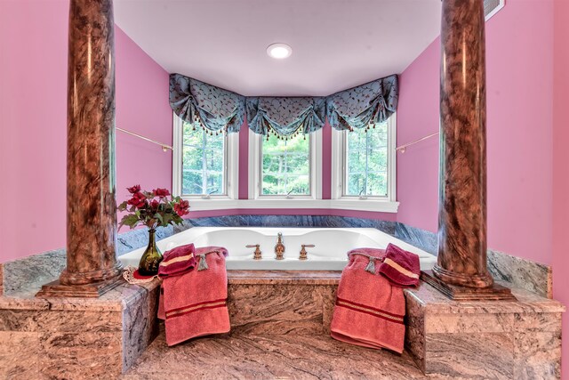 bathroom with a wealth of natural light and decorative columns