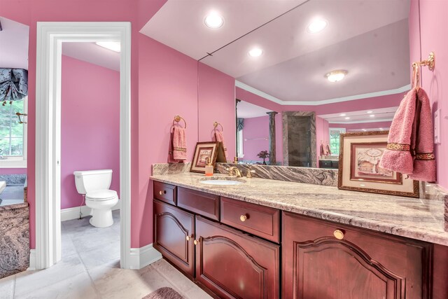 bathroom featuring oversized vanity, toilet, and tile floors