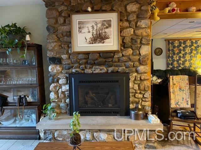 living room with a stone fireplace