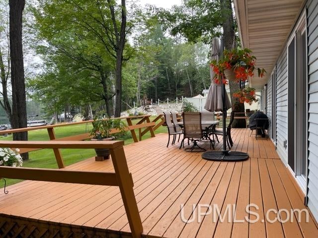 wooden terrace with a yard