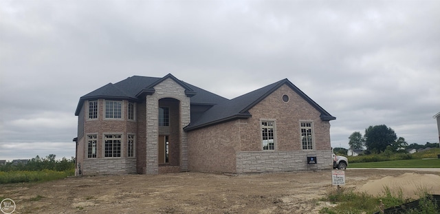 view of front of house featuring stone siding and brick siding